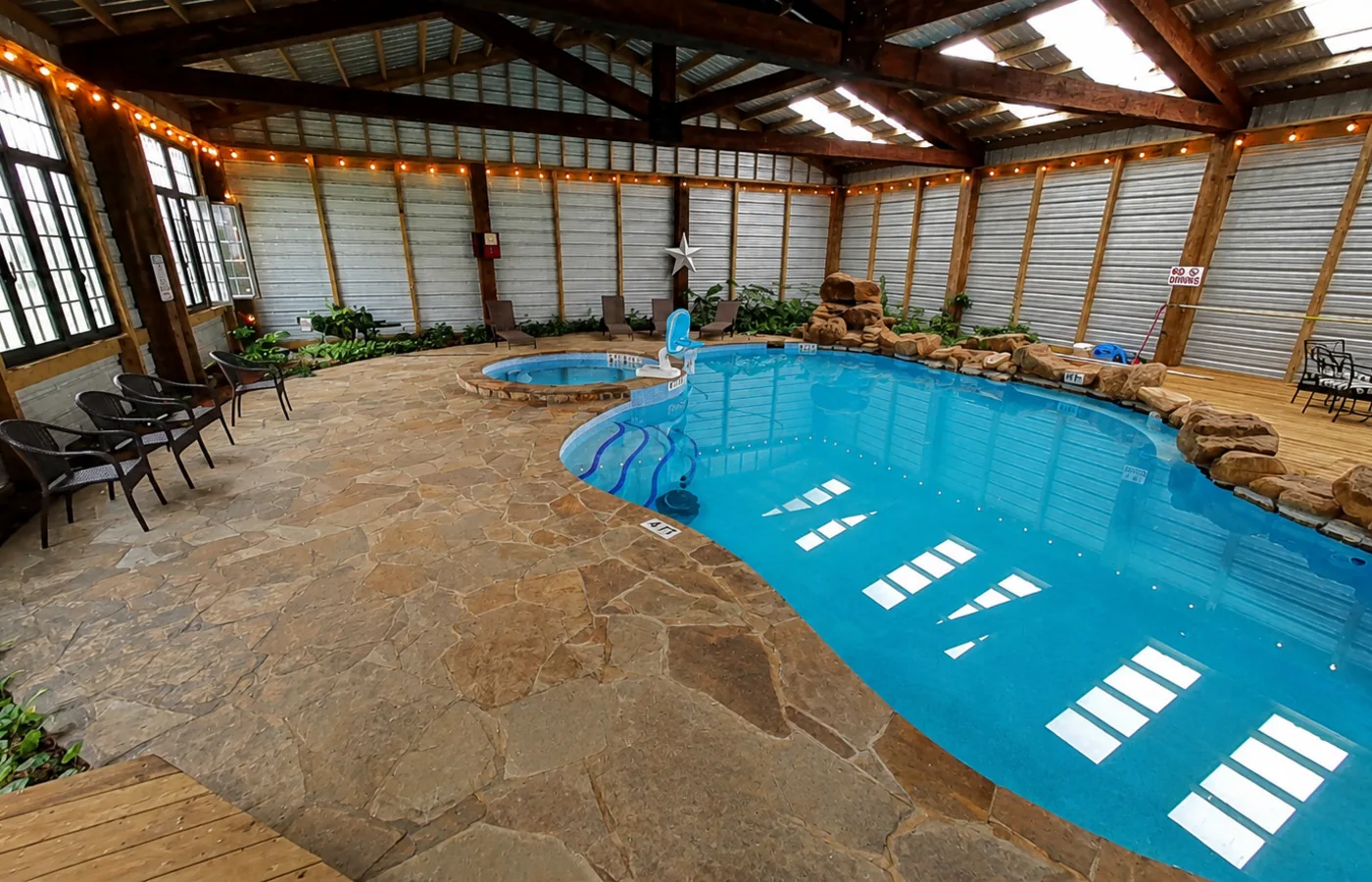 Indoor pool with rock waterfall at Twin Oaks